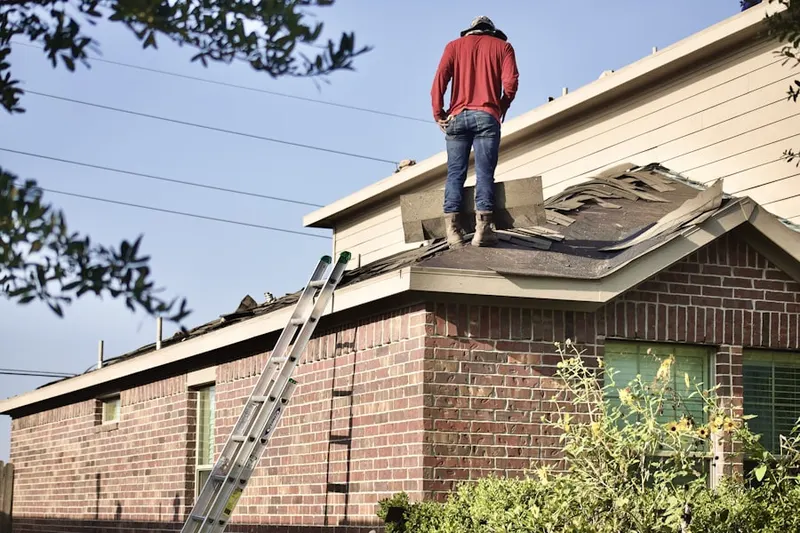 Professional roofer working on a residential roof in Mountain View Plaza